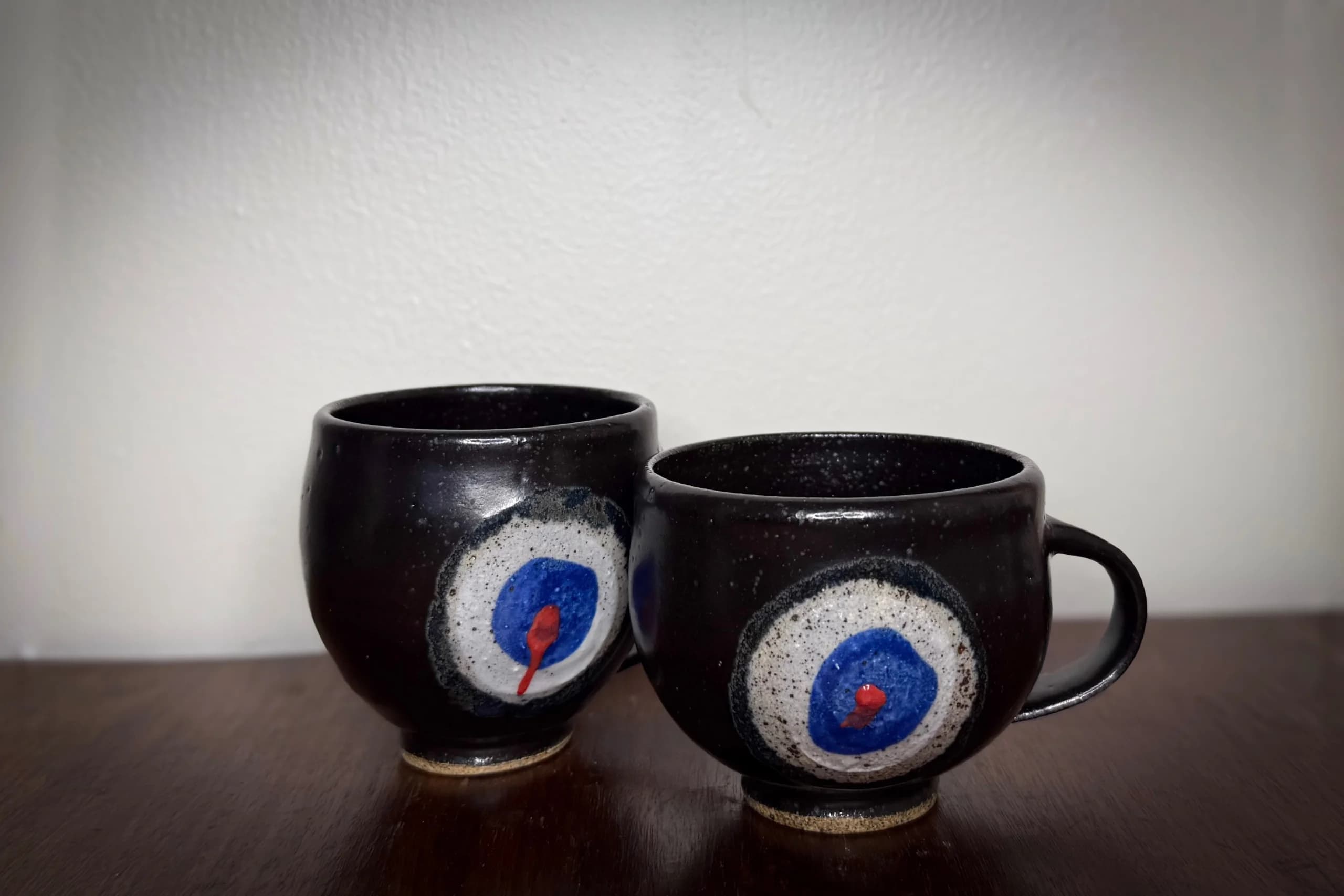 Charlie Kelly Ceramic Mug with Red and Blue Eye Design