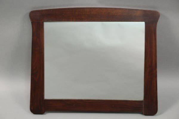 A rectangular wooden Arts And Crafts Oak Mirror with a dark stained frame, displayed against a neutral gray backdrop.