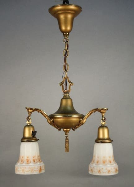 Sentence using product name: 11827. Antique Brass Turn Of The Century Chandelier With Original Art Glass Shades with three arms, each holding a bell-shaped, frosted glass shade decorated with floral patterns.