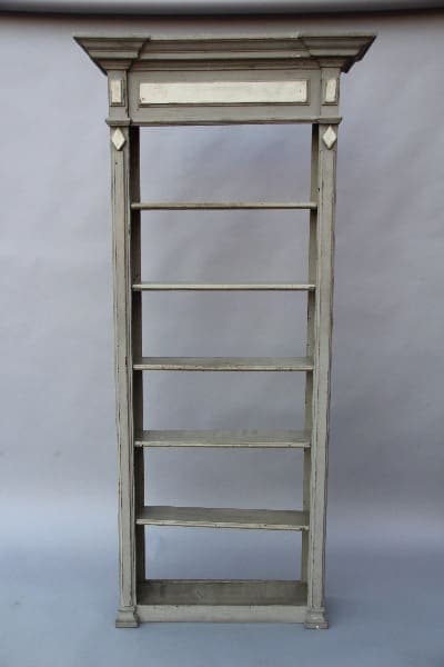 An antique 13733. Pair of Turn Of The Century Hall Bookcase with five shelves and a decorative top, set against a simple blue background.
