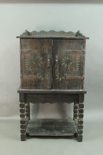 Antique 14392. Custom Monterey Style Bar Cabinet with floral designs on doors, featuring a scalloped top edge and supported by a sturdy base with a lower shelf.
