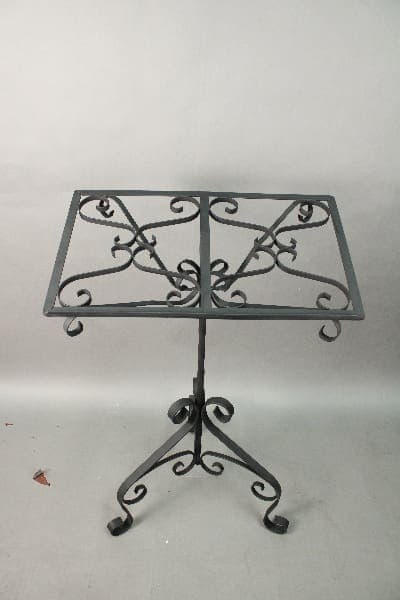 A 14465. Spanish Revival Wrought Iron Book Stand with ornate iron scrollwork and a dual tabletop, displayed against a plain gray background.