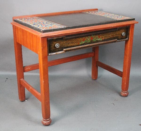 Vintage 14683. De Anza Hotel Desk With Tile with colorful tile top, decorative front drawer, and turned legs on a plain gray background.
