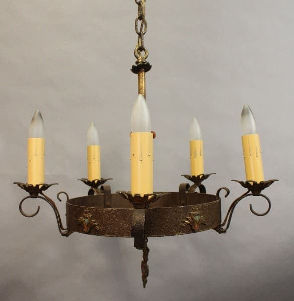 A circular 15403. Spanish Revival 5 Lights Chandelier with six candle-shaped light bulbs, decorative elements, and a central chain for hanging.