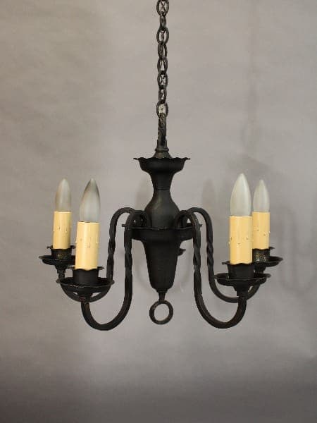 A 15418. 1920's Simple 5 Light Chandelier with five arms, each holding a white candle-shaped bulb, hanging from a chain against a gray background.