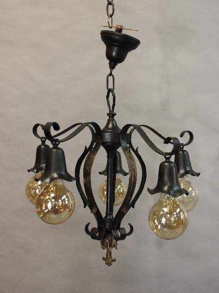 15436. Circa 1920's Spanish Revival With Down Lights with intricate metalwork and four glass bulbs hanging against a light background.