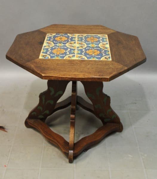 Octagonal 15858. Spanish Revival 1920's Tile Table with a colorful tile inlay on the top and a green floral pattern on the base, positioned on a plain background.