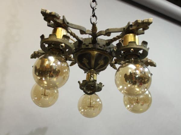15938. 1920's Ceiling Mount With Five Lights with four glowing light bulbs, hanging by a chain, against a white background.