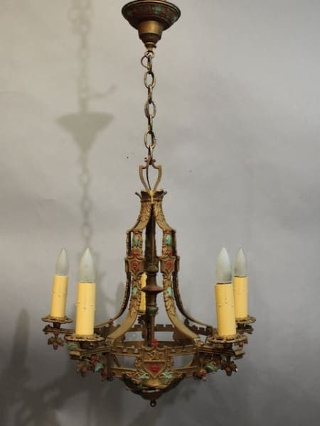 15954. Classic Spanish Revival Chandelier With Original Finish with ornate metalwork and painted details, featuring four candle-shaped bulbs, hanging from a chain.