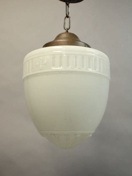 A 16045. 1920's Pendant With Original Glass Shade with decorative embossed details, hanging from a metallic fixture against a neutral backdrop.