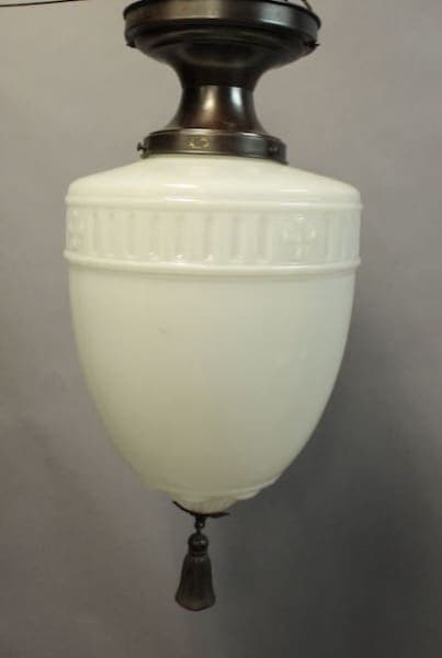 Vintage 1920's ceiling mount with glass pendant and tassel, featuring a classic pull-chain.