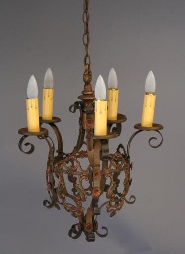 3505. Charming Chandelier w/ Polychrome Finish with five electric candle bulbs, featuring intricate metal scrollwork and a faded gold finish, hanging against a gray background.