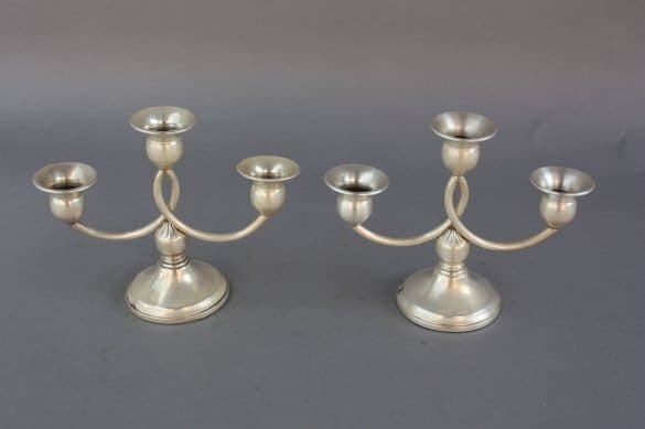 Two 7409, pair of silver candelabras with three holders and curved arms, on a gray background.