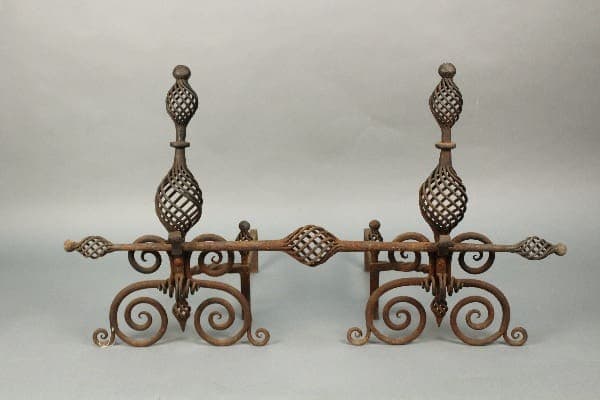 11464. Pair Of 1920's Andirons With Great Wrought Iron Work with intricate scroll designs and spherical elements on a plain background.