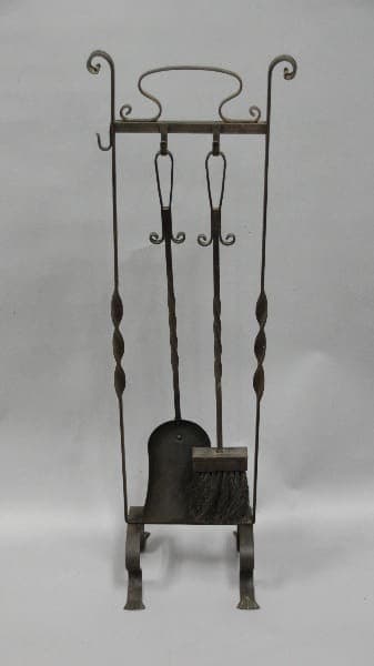 An antique 12083. 1920's Wrought Iron Fire Tool Set with a shovel and brush, set against a plain gray background.