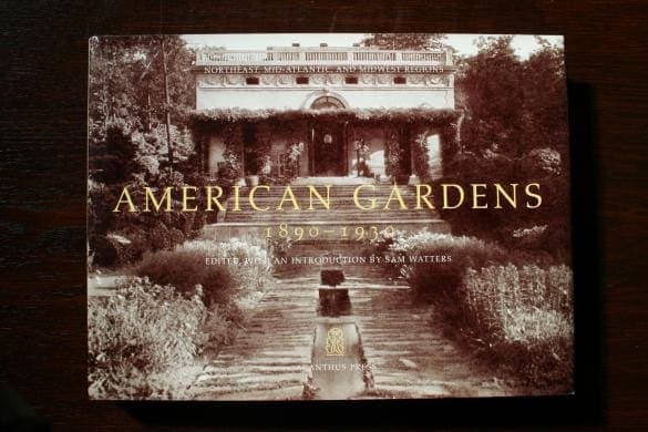Product Name: 1284. American Gardens, 1890-1930 by Sam Watters Sentence with replaced product: Book titled "1284. American Gardens, 1890-1930 by Sam Watters" with a sepia-toned cover photo of a garden path, displayed on a wooden surface.