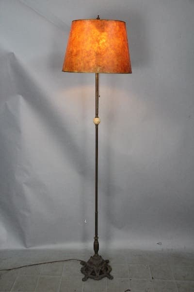 Antique floor lamp with a brown shade.