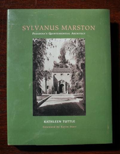A green book titled "1299. Sylvanus Marton Pasadena's Quintessential Architect" by Kathleen Tuttle, featuring a black-and-white architectural photo on the cover.