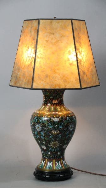 13046. Turn Of The Century Cloisonne Table Lamp With New Mica Shade with a colorful ceramic base featuring floral designs and a hexagonal beige shade.