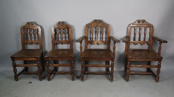 Four vintage wooden chairs in a row.