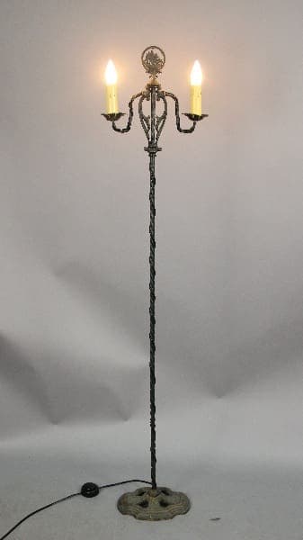 Vintage three-light floor lamp with candles.