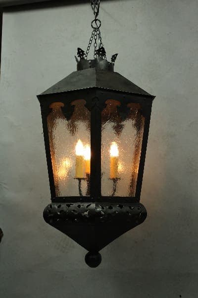 Hanging vintage lantern with glowing candles.