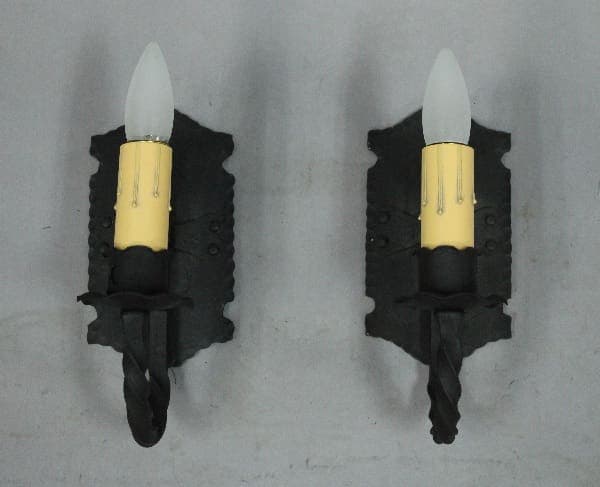 Two decorative wall-mounted candle holders.