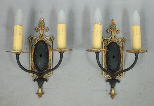 Wall sconces with ornate candle holders.