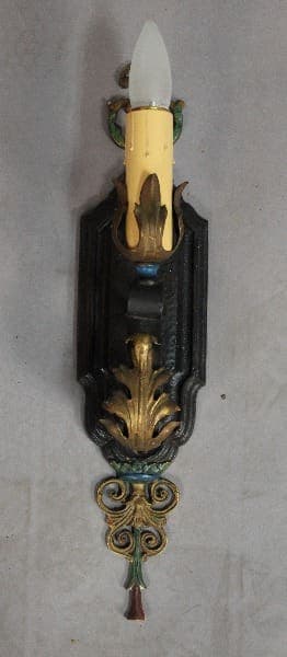 Ornate wall sconce with candle design.