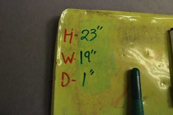 Dimensions listed on yellow surface with marker.