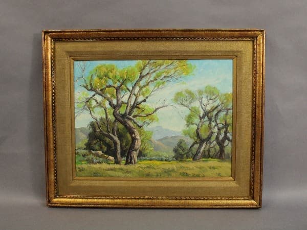 Framed painting of green trees and landscape.
