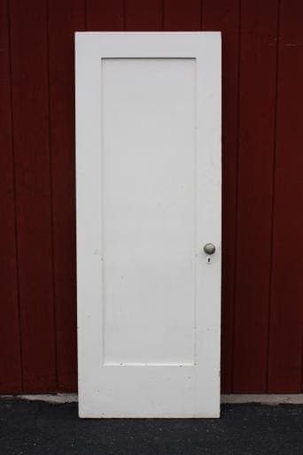 White door against a red background.