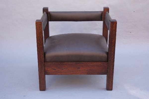 A dark wooden 8814. Arts And Crafts Mission Cube Chair with a leather cushion and visible grain texture, set against a neutral gray background.