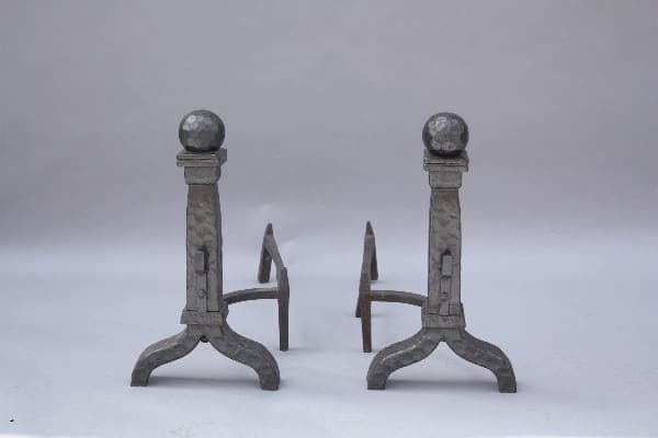 Two 9293. 1920's Spanish Revival Cast Iron Andirons with ball finials and arched legs on a gray background.