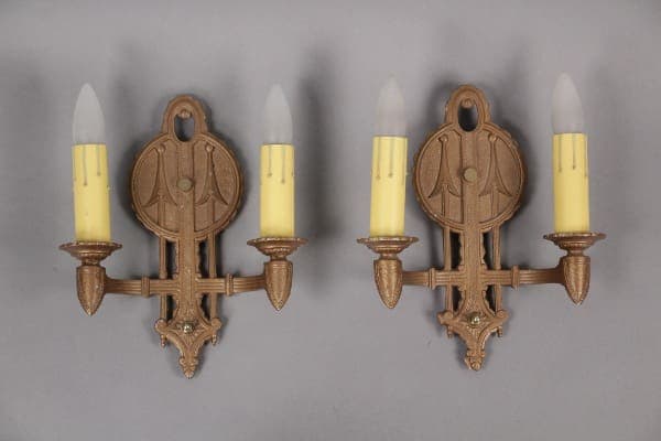 Ornate wall sconces with candle bulbs.