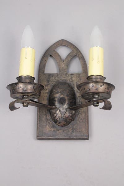 Ornate metal two-light wall sconce.