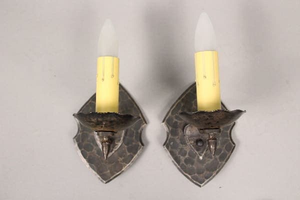 Two wall sconces with candle-like bulbs.