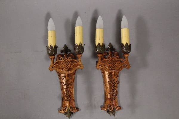 Ornate wall sconces with candle-like bulbs.