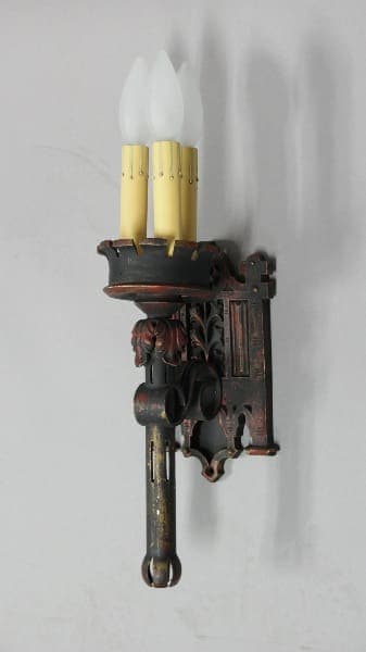 Vintage wall sconce with three candle lights.