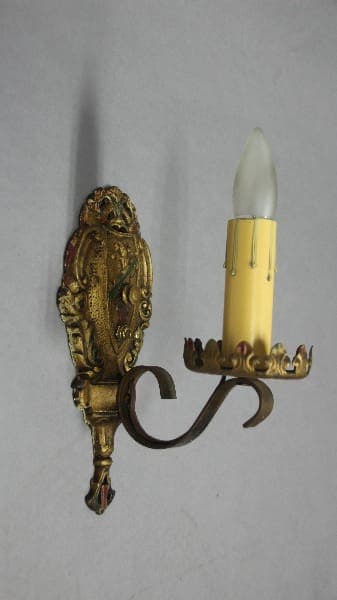 Ornate candle holder with yellow candle.