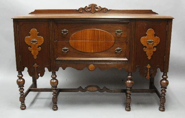 Antique wooden sideboard with ornate details.