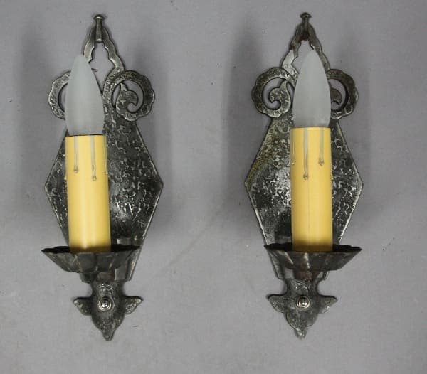 Two candle sconces with faux candles.