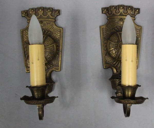 Two vintage wall sconces with candle lights.