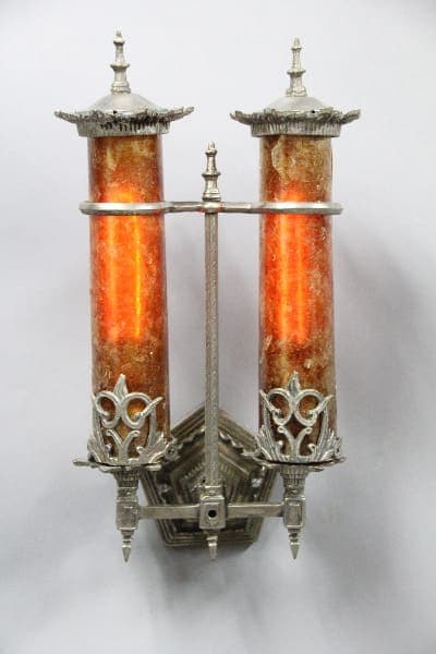 Artistic vintage wall sconce with glowing tubes.