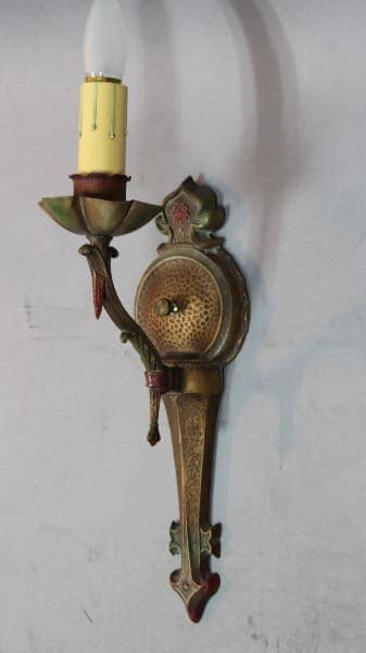 Vintage wall sconce with decorative design.