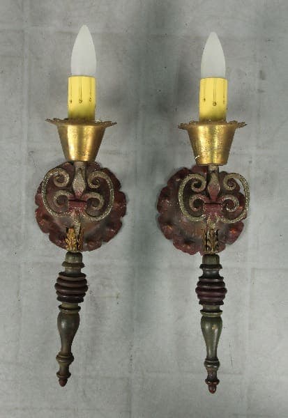 Two vintage wall sconces with candles.