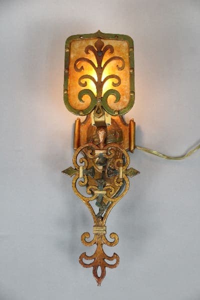 Vintage wall sconce with ornate design.