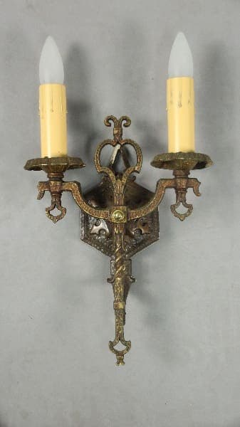 Antique wall sconce with two candles.