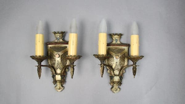Two vintage wall sconces with candleholders.