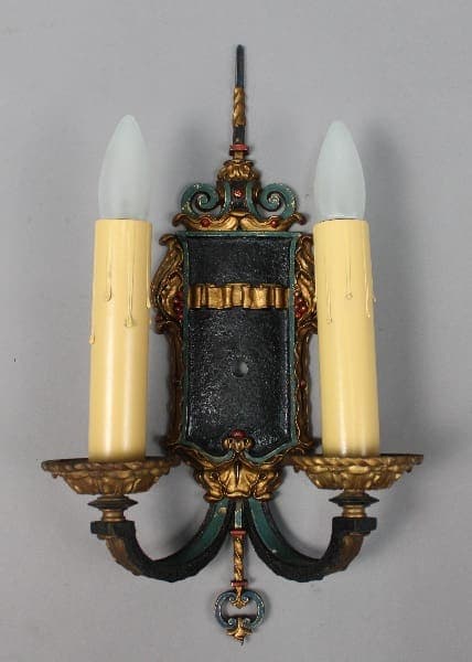 Vintage wall sconce with two candle holders.